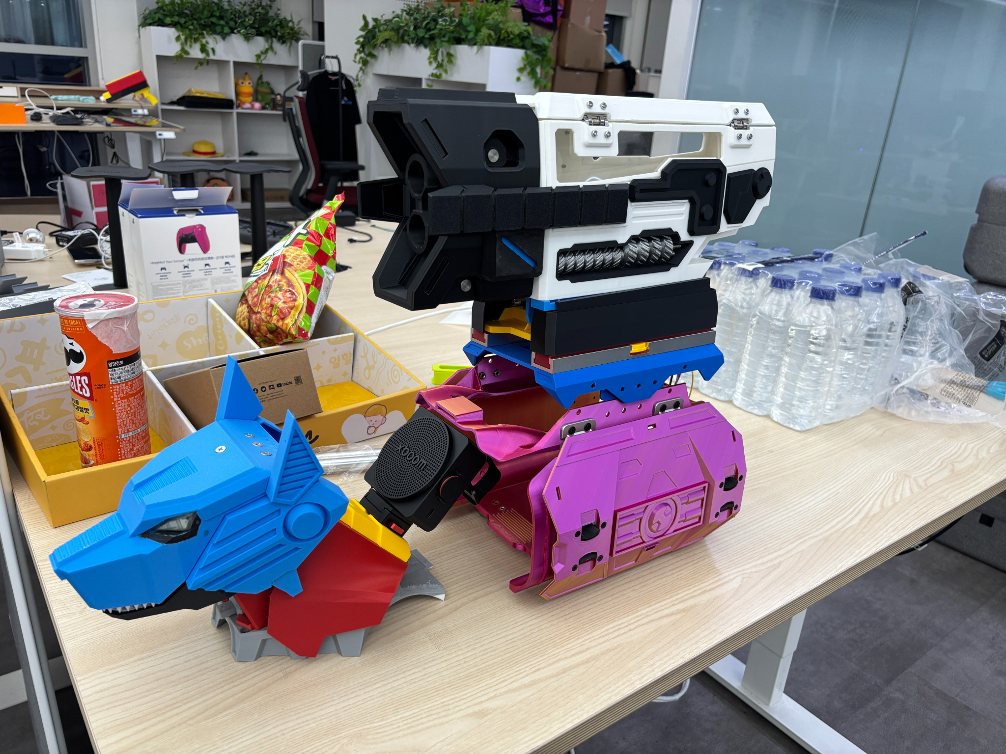 The real STRYKER prototype with its custom robot shell and mounted blaster, on the KongLabs workbench